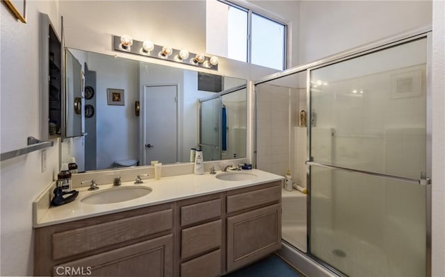 bathroom featuring toilet, walk in shower, and vanity