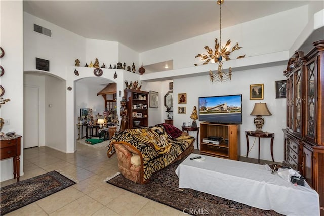 living room with an inviting chandelier and light tile patterned floors