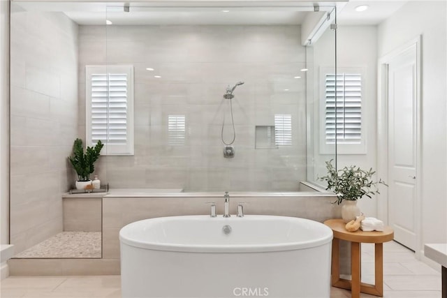 bathroom featuring tile walls, tile patterned floors, and independent shower and bath