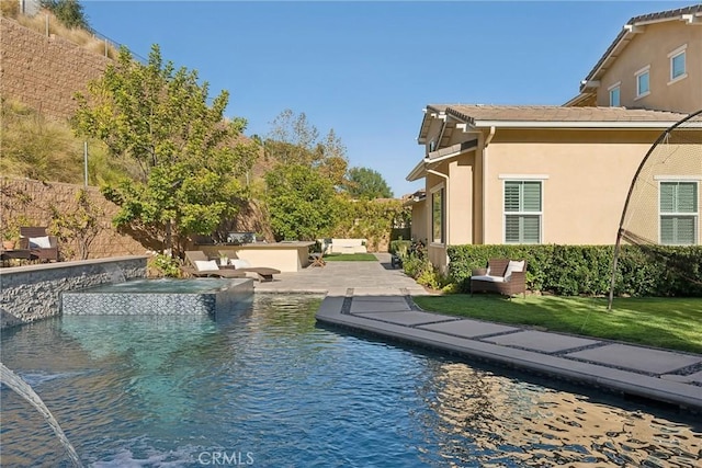 view of swimming pool with a lawn, a patio, and an in ground hot tub