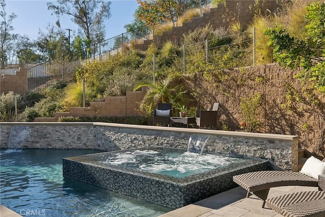 view of pool featuring a jacuzzi and pool water feature