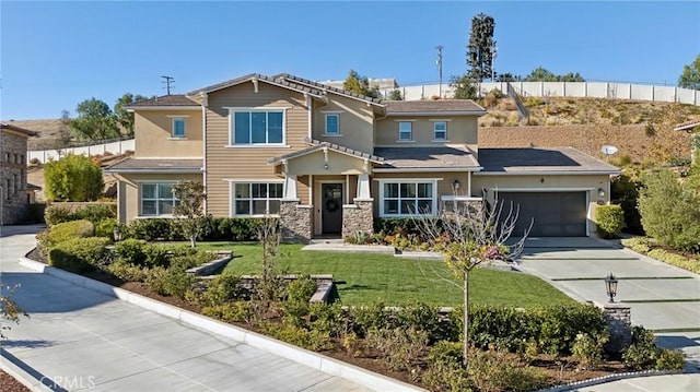 view of front of home featuring a garage and a front yard