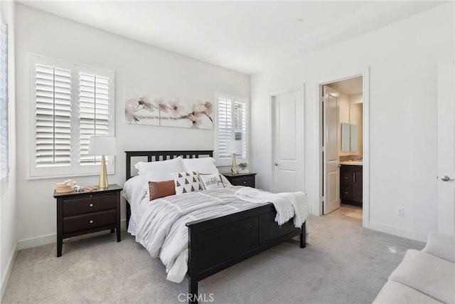 carpeted bedroom featuring ensuite bath