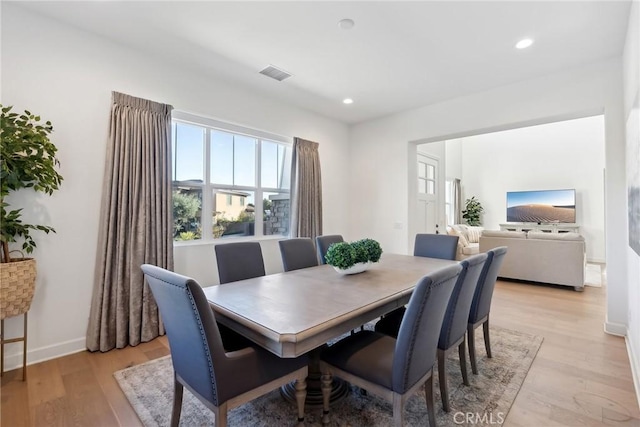 dining space with light hardwood / wood-style flooring