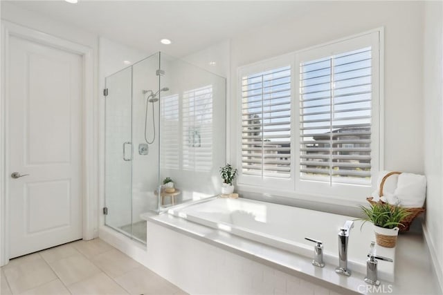 bathroom with plus walk in shower and tile patterned flooring