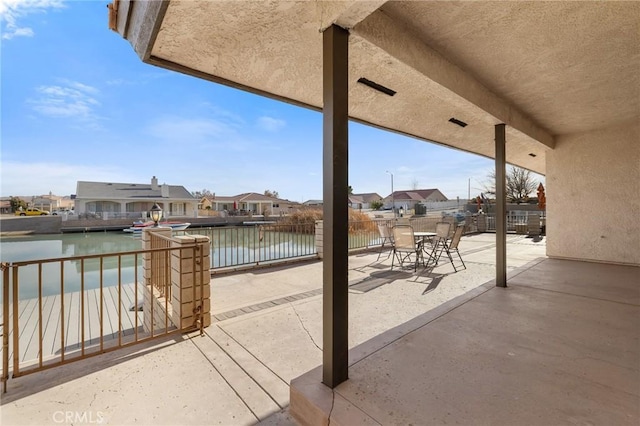 view of patio with a water view