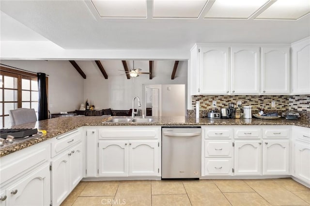 kitchen featuring white cabinetry, ceiling fan, dishwasher, vaulted ceiling with beams, and sink