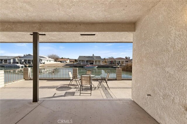 view of patio featuring a water view