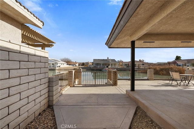 view of patio / terrace with a water view and a pergola