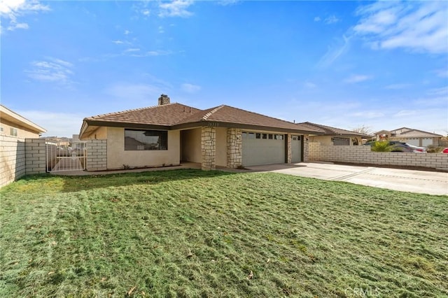 view of front of property featuring a garage and a front yard