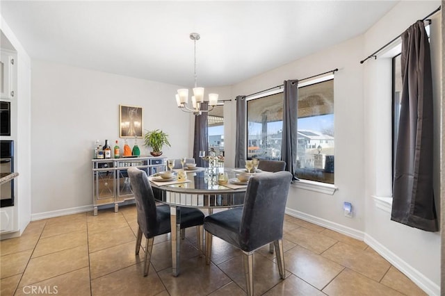 dining room with an inviting chandelier and tile patterned flooring