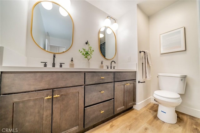 bathroom featuring hardwood / wood-style floors, toilet, and vanity