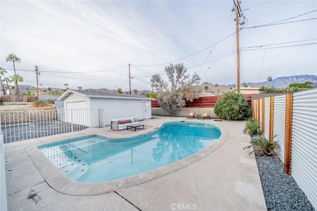 view of swimming pool with an outdoor structure and a garage