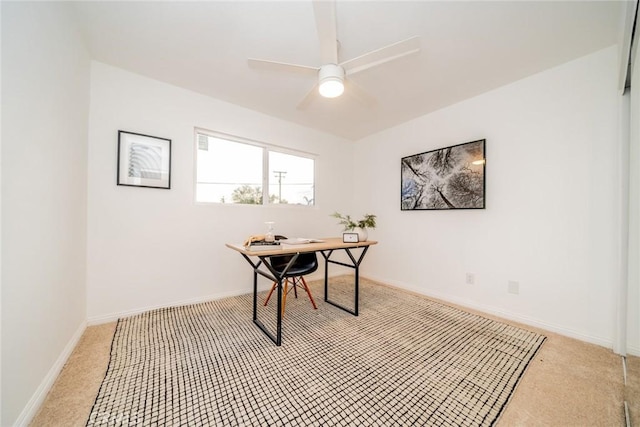 carpeted office space featuring ceiling fan