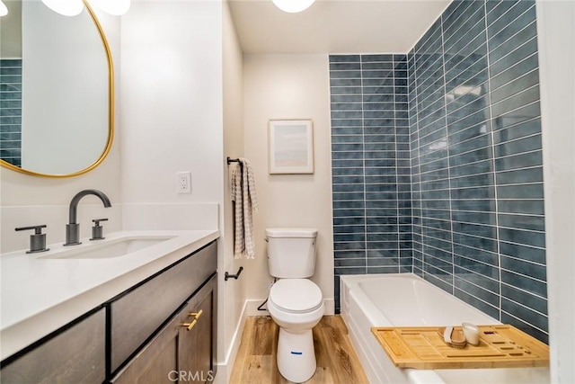 bathroom with toilet, wood-type flooring, and vanity