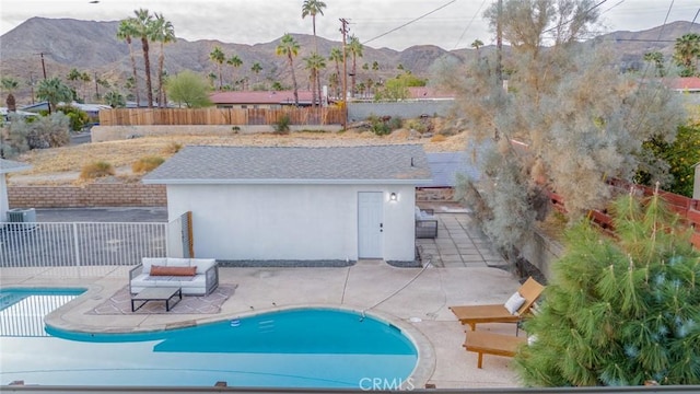 view of pool with a patio area and a mountain view