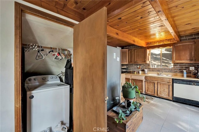 laundry room featuring washer / clothes dryer, sink, light tile patterned floors, and wooden ceiling