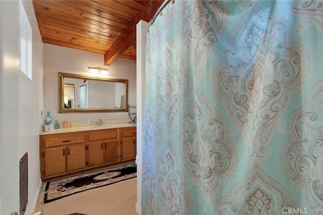 bathroom with wood ceiling, tile patterned floors, vanity, and beamed ceiling