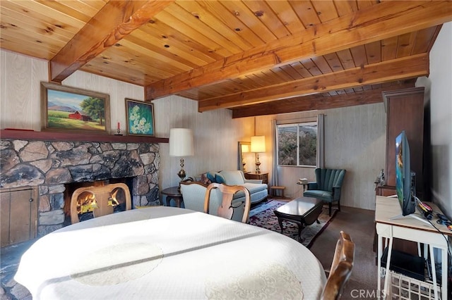 bedroom with wood ceiling, beamed ceiling, and a fireplace