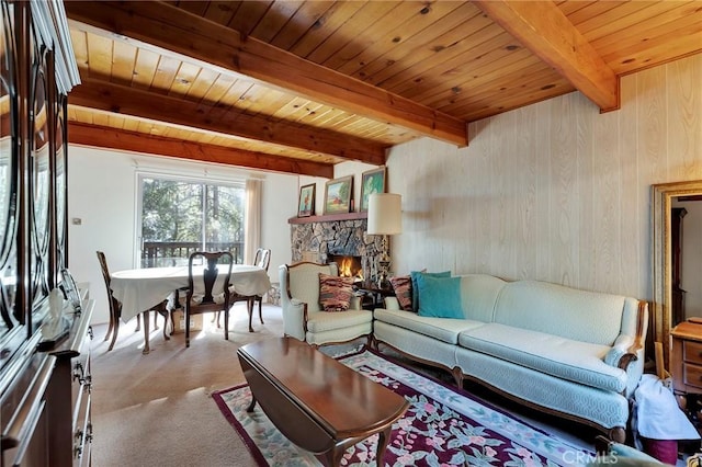 living room with wood ceiling, a fireplace, beamed ceiling, and wooden walls