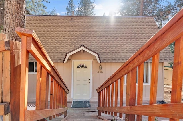 view of exterior entry featuring a wooden deck