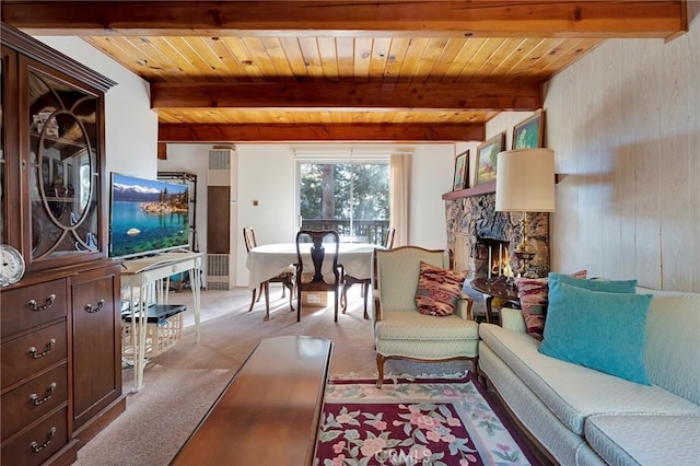 living room featuring wooden ceiling, light colored carpet, a stone fireplace, and beamed ceiling