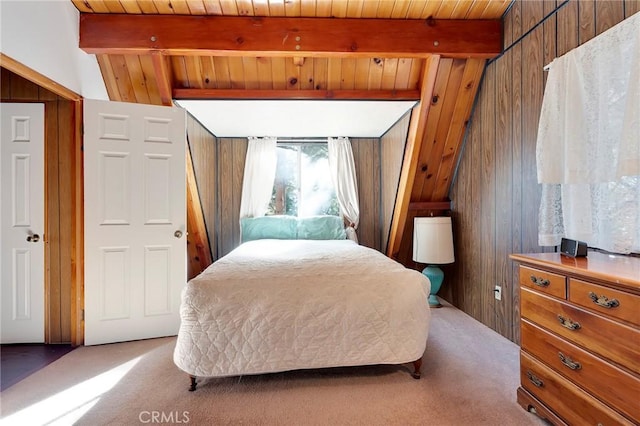 carpeted bedroom with beamed ceiling, wooden walls, and wooden ceiling