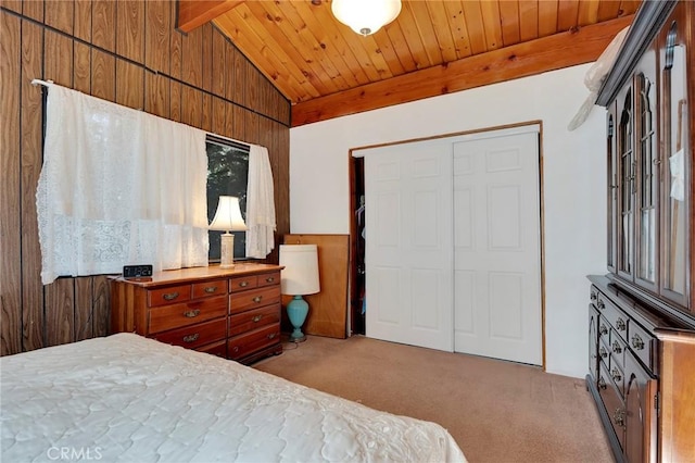 bedroom featuring a closet, light colored carpet, and wooden walls