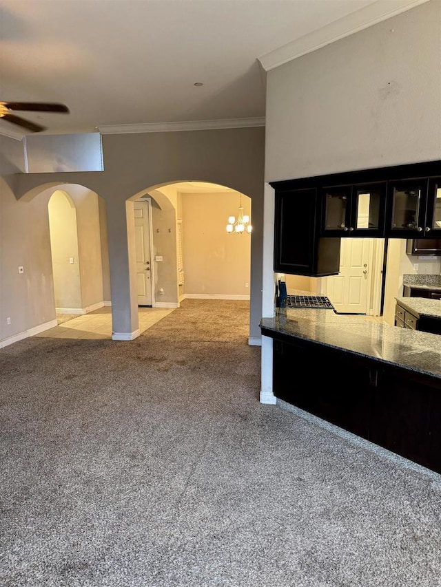 kitchen featuring ceiling fan with notable chandelier, ornamental molding, and light colored carpet