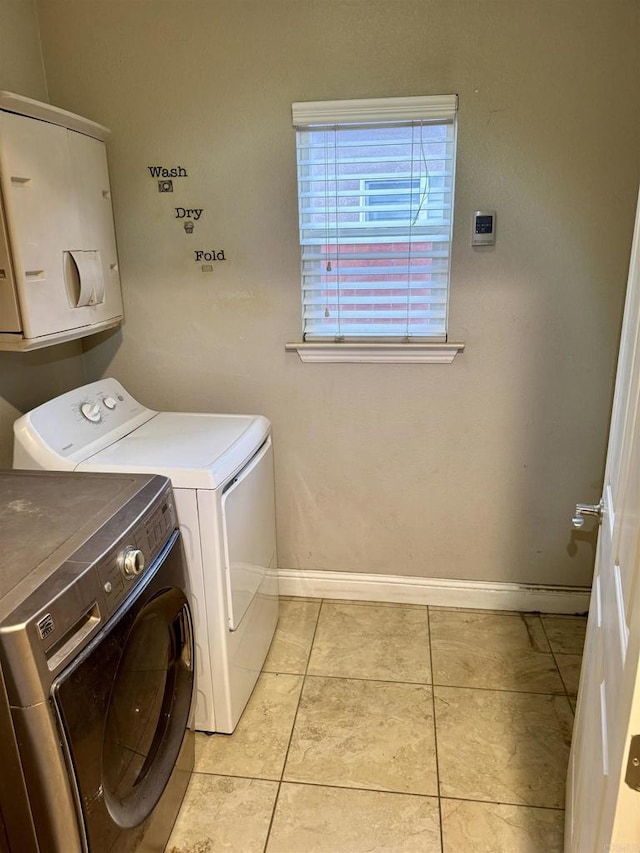 laundry area featuring light tile patterned floors and independent washer and dryer