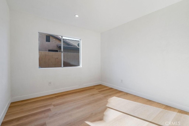 unfurnished room with hardwood / wood-style floors