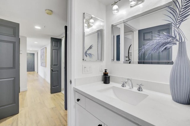 bathroom with hardwood / wood-style flooring and vanity