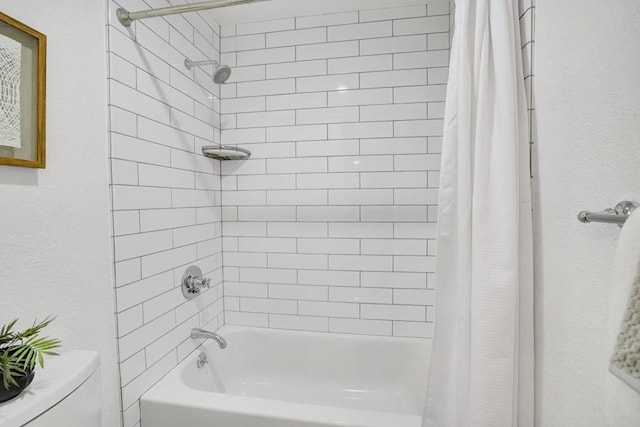 bathroom featuring toilet and shower / bath combo