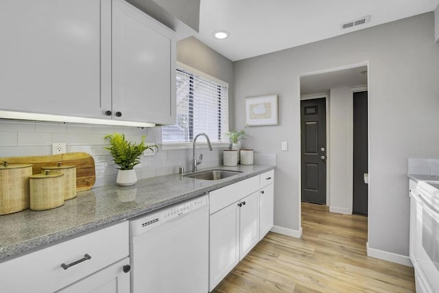 kitchen featuring sink, white cabinetry, stove, white dishwasher, and light wood-type flooring