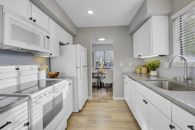 kitchen featuring white cabinetry, sink, light wood-type flooring, light stone counters, and white appliances