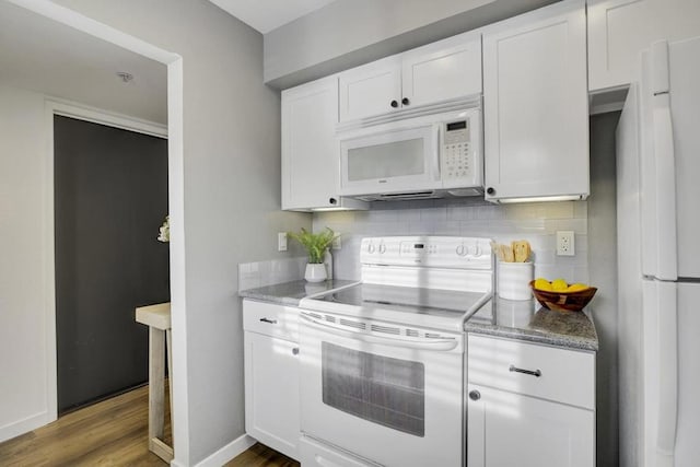 kitchen featuring tasteful backsplash, white cabinetry, hardwood / wood-style flooring, and white appliances