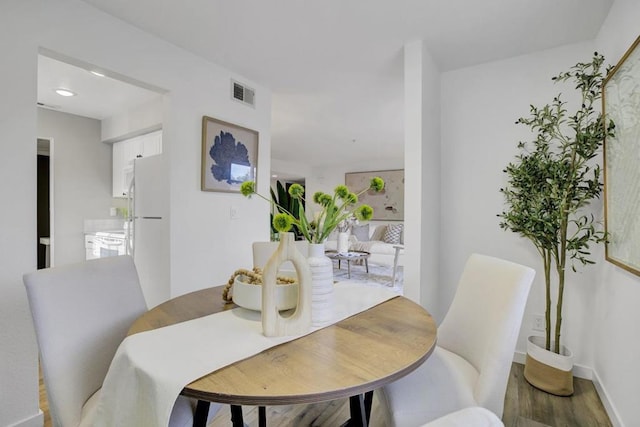 dining space featuring hardwood / wood-style floors