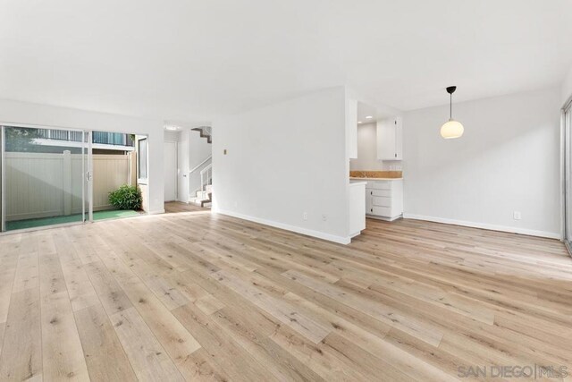 unfurnished living room with light hardwood / wood-style flooring