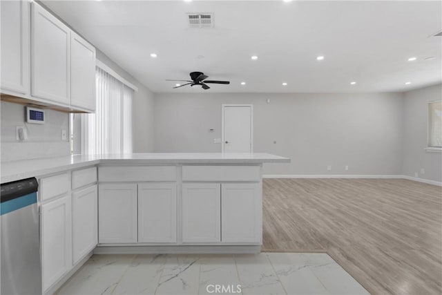 kitchen with ceiling fan, white cabinets, kitchen peninsula, and dishwasher