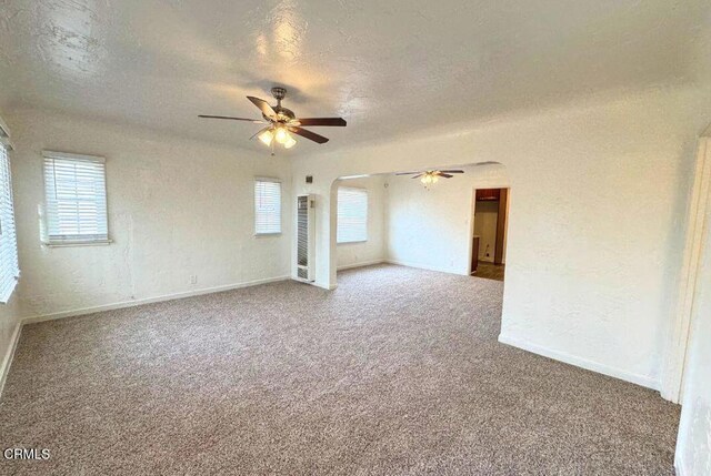 carpeted empty room featuring a textured ceiling and ceiling fan