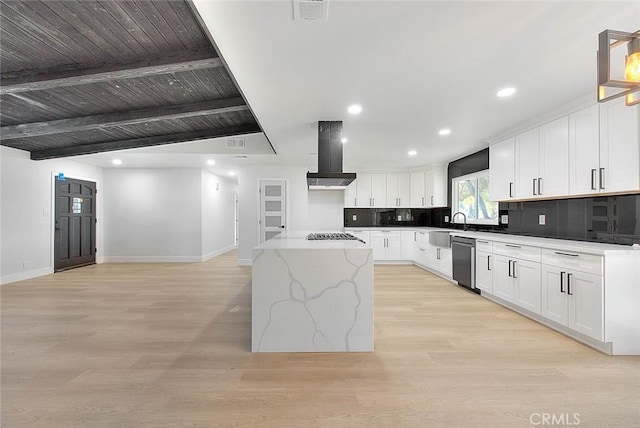 kitchen featuring light stone countertops, white cabinets, a center island, appliances with stainless steel finishes, and island exhaust hood