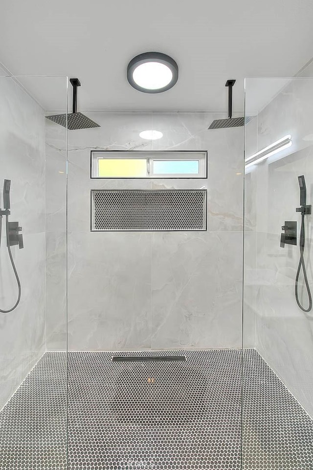 bathroom with tiled shower