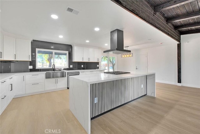 kitchen featuring wood ceiling, a kitchen island, white cabinetry, sink, and island range hood