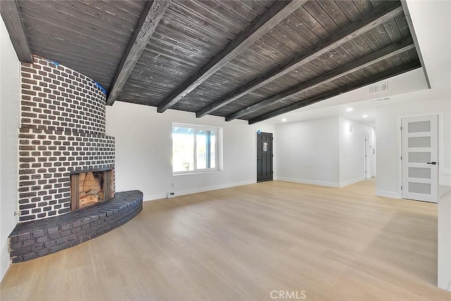 unfurnished living room featuring a brick fireplace, wooden ceiling, light hardwood / wood-style flooring, and lofted ceiling with beams