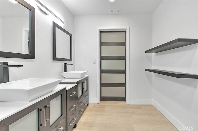 bathroom with vanity and wood-type flooring