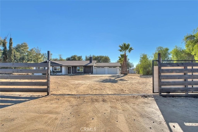 view of gate with a garage