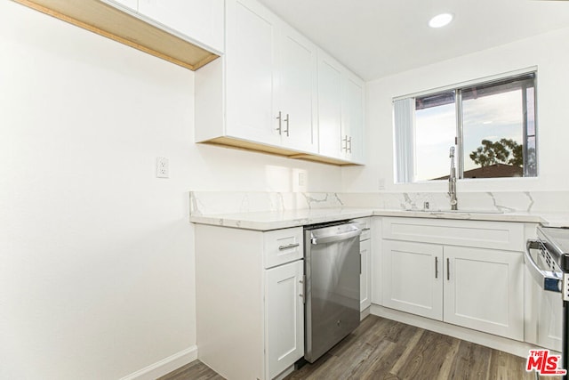 kitchen featuring appliances with stainless steel finishes, dark hardwood / wood-style flooring, light stone counters, sink, and white cabinets