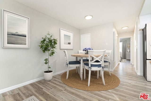 dining area with light wood-type flooring