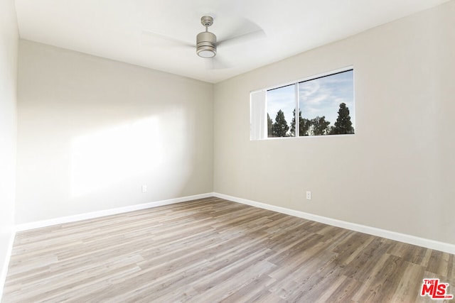 spare room featuring light hardwood / wood-style floors and ceiling fan