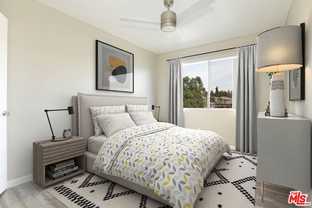 bedroom featuring ceiling fan and light hardwood / wood-style floors